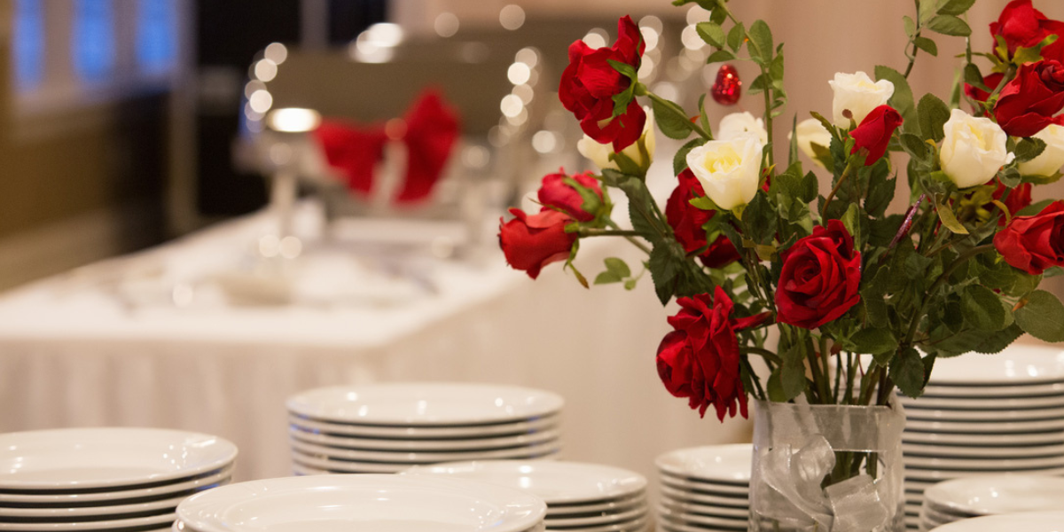 Banquet table with white linen and flowers in a vase