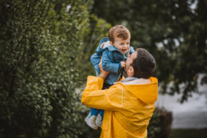 Father and son having fun on rainy day.