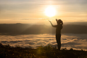 Girl praying in the mountains